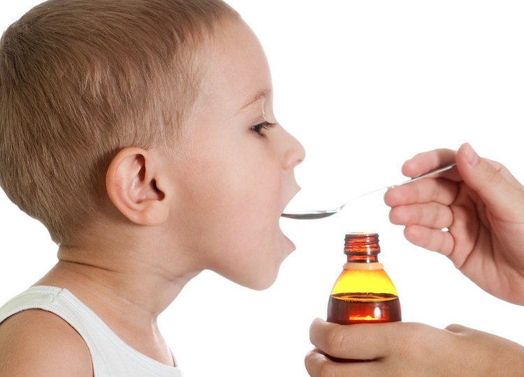 Kid getting a scoop of medicine