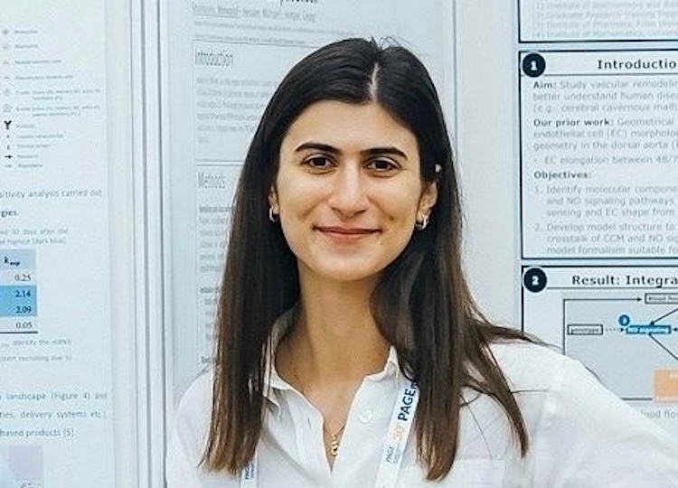 Elena Righetti's picture in front to her poster at a conference